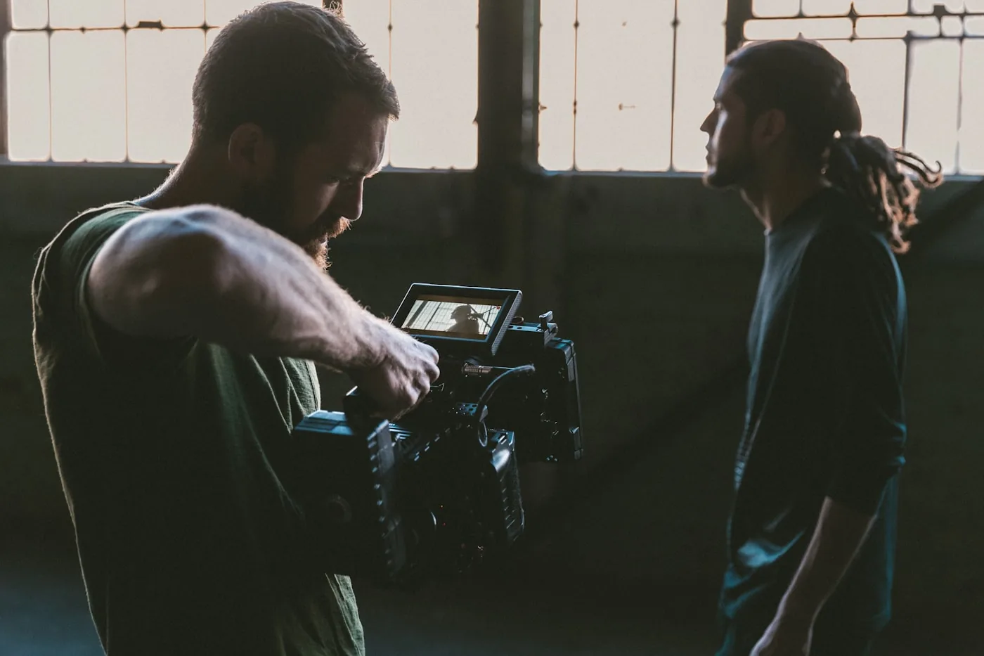 A camera operator filming a subject during a documentary interview