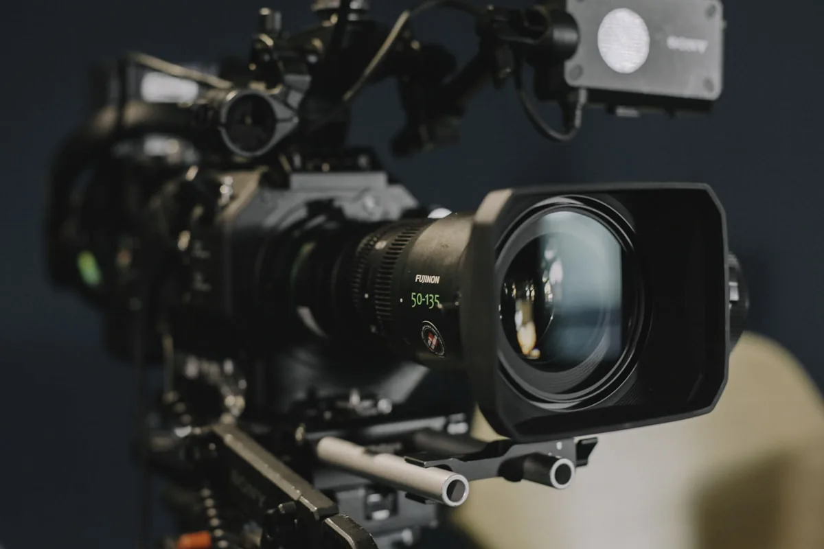 Close detail of a professional cinema camera body and lens