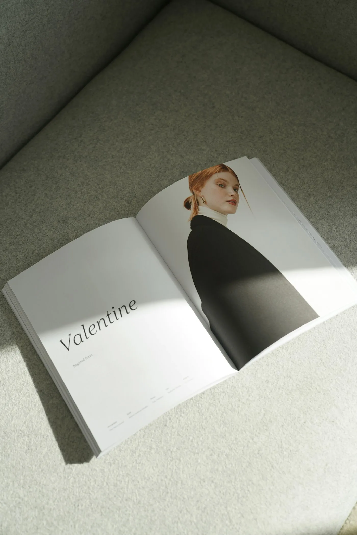 An open magazine spread with a full-page editorial portrait